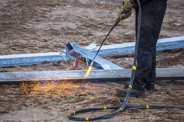 istock A worker cut steel beams using propane-oxygen torch.