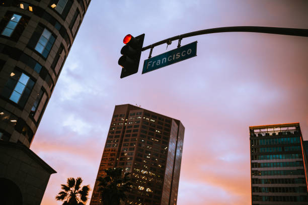 Vibrant sunset casts warm light over a deserted city street, highlighting urban architecture and tranquil atmosphere