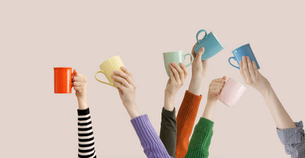 istock Many different arms raised up holding coffee cup 1138719970