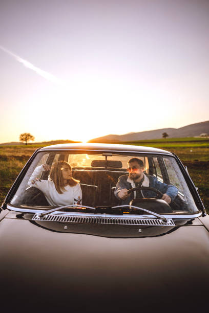 istock Couple driving in car on sunny day 1138720902
