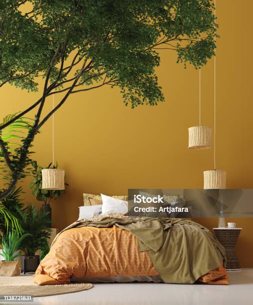 Bedroom Interior In Bohemian Style With Patterned Bed And Floral Corner Stock Photo - Download Image Now