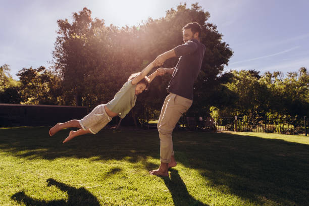istock Man playing with his son in the park 1138721869