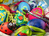 Close up of a basket with hand-painted easter eggs and brushes