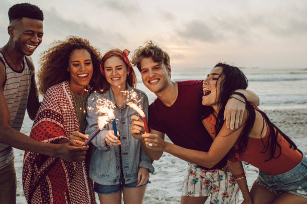 istock Friends partying on the beach with sparklers 1138728071