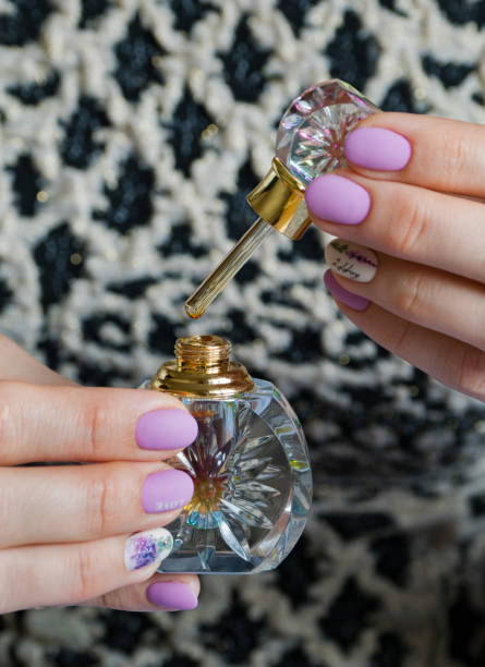 istock Oil perfume in a glass bottle in her hands. 1138730467