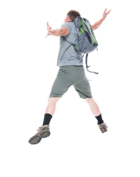 istock Friendly male hiker is jumping with excitement, rear view 1138734099