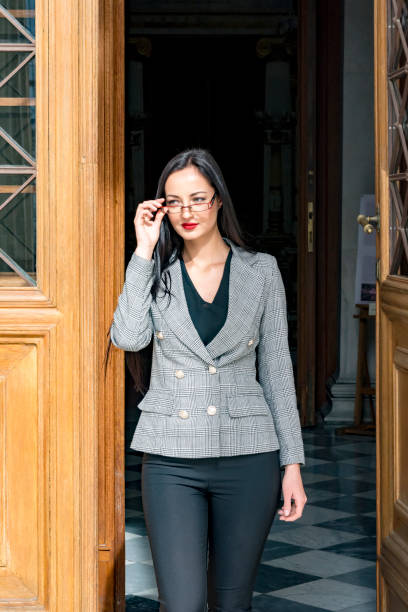 istock Young woman exiting from a door 1138734879