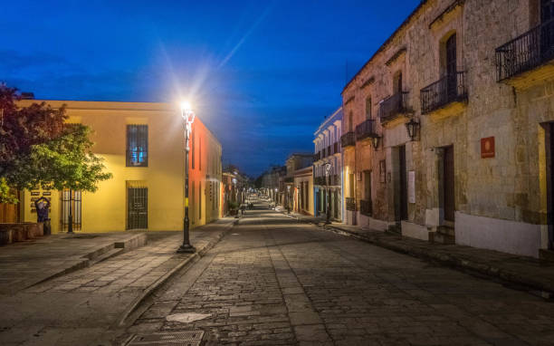 Empty Street of Oaxaca Mexico One of the main streets in Oaxaca Mexico during blue hour mexico street scene stock pictures, royalty-free photos & images