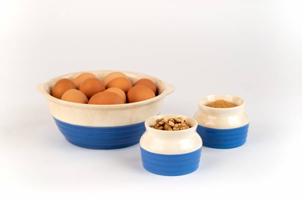 istock Farm Fresh Organic Free Range Eggs, Walnuts, Organic Sugar in Blue and White Bowls. 1138742764