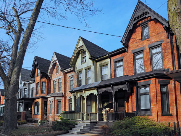 Row of old Victorian style brick houses with gables Row of old Victorian style brick houses with gables victorian houses exterior stock pictures, royalty-free photos & images