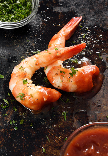 Plate of boiled king prawns on white isolated background