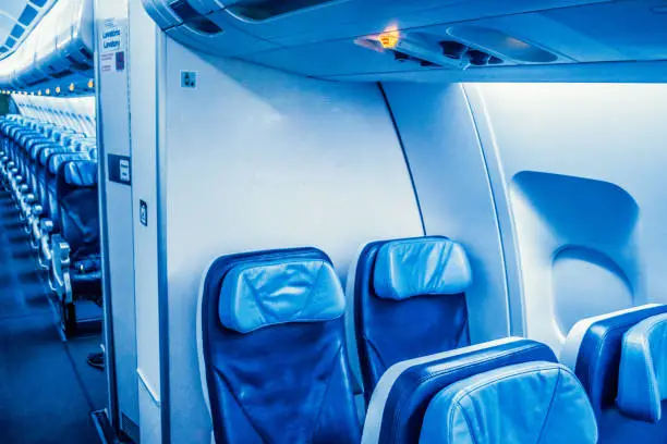 Passenger Cabin economy class of wide fuselage aircraft, a.k.a. two aisles. Aircraft with led lighting triggered in color display mode.