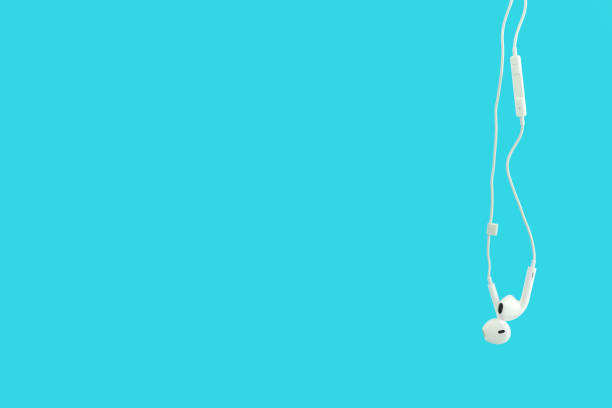 istock White hanging ear buds headphones isolated on a blue 1138745025