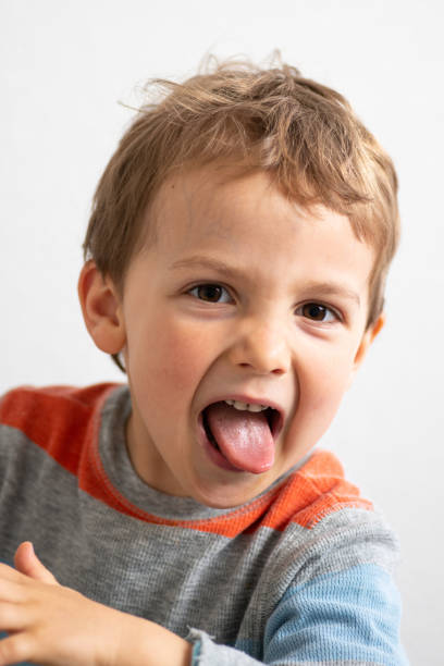 istock Smiling three years old child with his tongue out 1138745318
