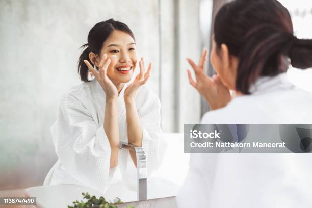 Asian Woman Cleaning Face Front Of Mirror Skin Care And Cosmetic Removal Concept Stock Photo - Download Image Now