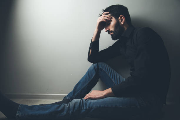 istock sad man sitting hand in face 1138750734