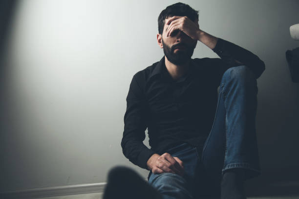 istock sad man sitting hand in face 1138750736