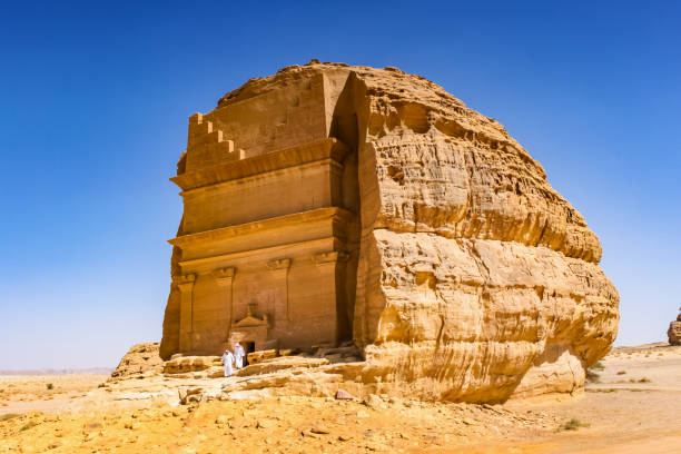 Qasr Al-Farid rock tomb in Mada'in Saleh Saudi Arabia People visit Qasr Al-Farid, the largest tomb of Mada'in Saleh. It dates from the time of the Nabatean kingdom, now a UNESCO world heritage site near Al Ula, Saudi Arabia. madain saleh photos stock pictures, royalty-free photos & images