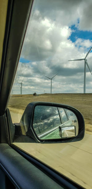 istock View of field and turbines from inside moving car 1138757323
