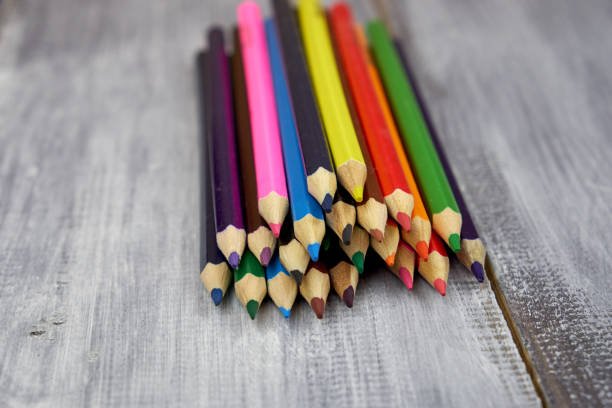 istock Colored pencils on grey wooden background 1138769971