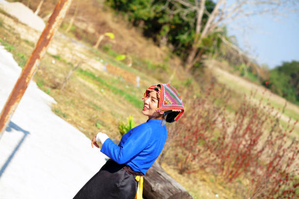 Thai woman doing and performing rumthai dance outdoors in rural and old historical village Ban Tai Dam in province of Loei in north Thailand. Woman is traditionally dressed.