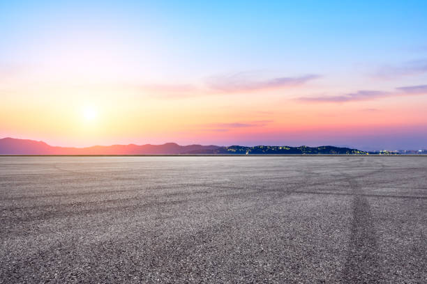 istock Asphalt race track and beautiful mountain nature landscape at sunset 1138771221