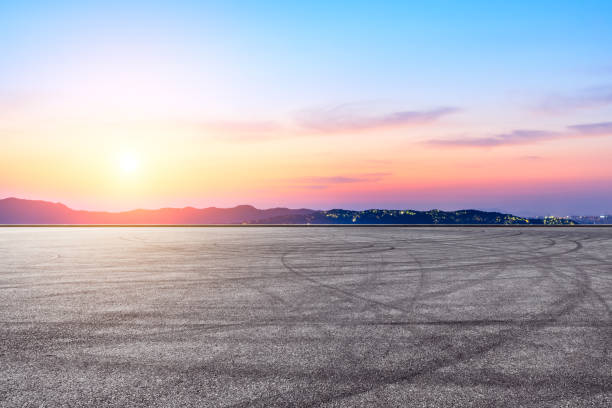 istock Asphalt race track and beautiful mountain nature landscape at sunset 1138771421