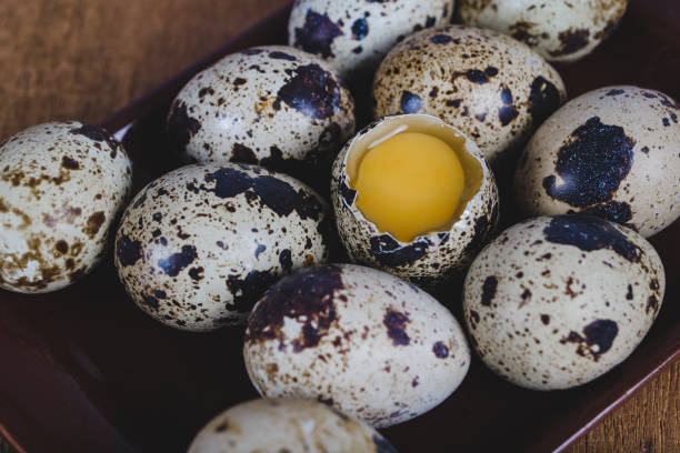 istock Quail eggs in plate On the old wood table background. 1138771658