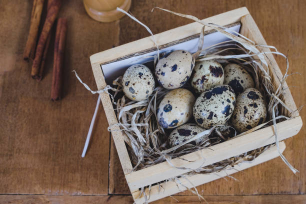 istock Quail eggs in wood block On the old wood table background. 1138771685