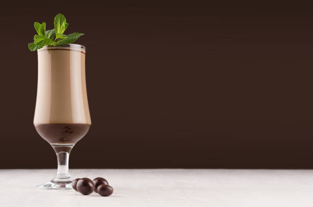 istock Exquisite chocolate layers dessert with fresh green mint and with round chocolates in dark brown interior, copy space. 1138773165