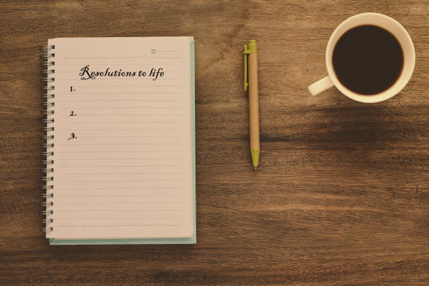 istock Resolutions to life text on book note with cup of coffee, pen and 1138773210