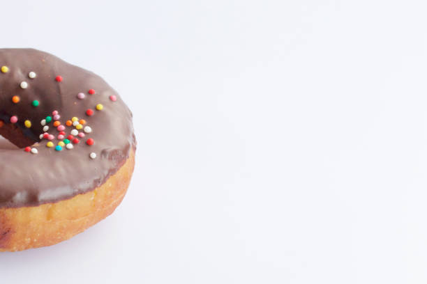istock American donuts, glazed with melted chocolate and decorated with sprinkling, lie on a platter. 1138779412