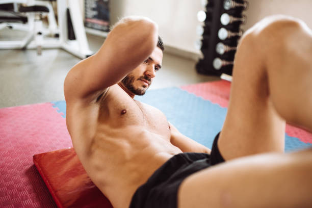 istock man doing abs in the gym 1138782751