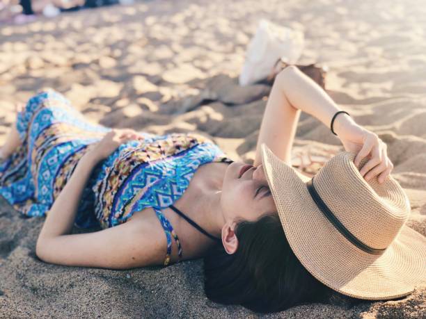 istock Young Asian woman enjoying her time on a beach 1138785399