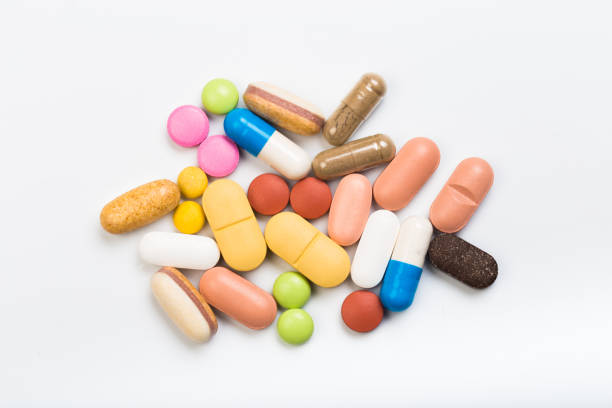 istock set of multi-colored tablets and capsules on a white background - Image 1138786090