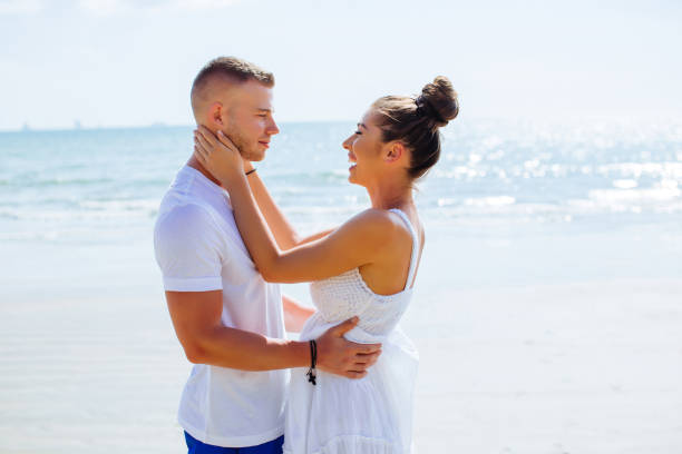 istock Couple in love flirting outdoors on the beach 1138786217