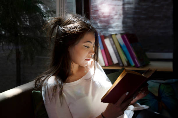 istock Young woman reading book 1138789370