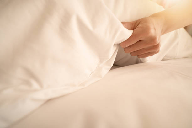 istock Female Hand set up white bed sheet in room hotel 1138791715