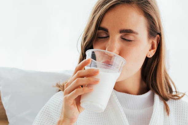 istock Young woman drinking milk from cup 1138794569