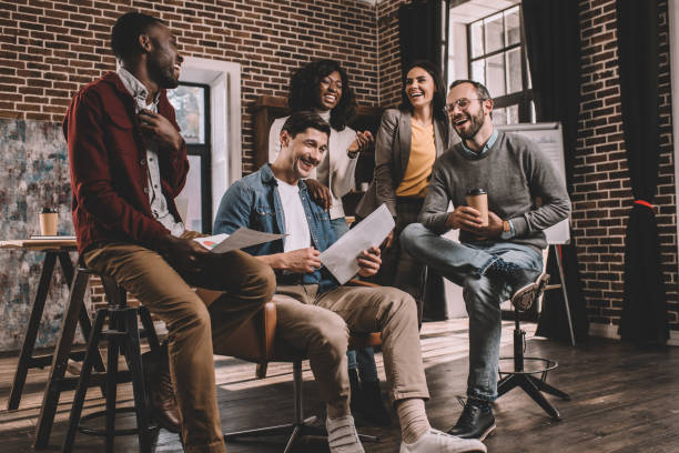 istock multiethnic group of colworkers smiling and discussing together new project in modern loft office 1138794583