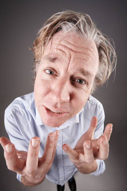 istock Mature man looks up, gesturing, begging pathetically 1138796867