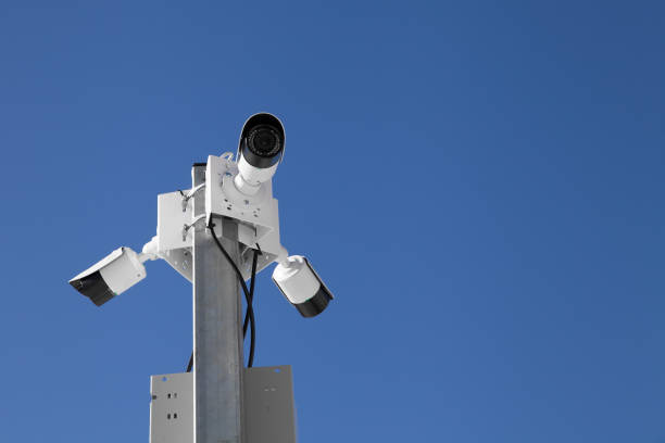 istock three surveillance cameras against a blue sky 1138797500