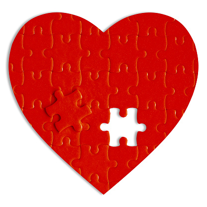 Red heart puzzle isolated on white background.