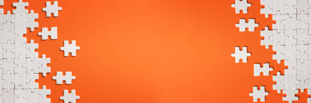 istock White details of puzzle on orange background 1138797714