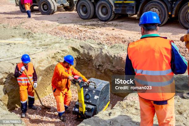 Boss Oversees Control Work On Construction Site Stock Photo - Download Image Now - Shaking, Watching, Engineer