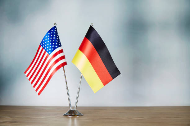 istock American and German flag standing on the table 1138800795