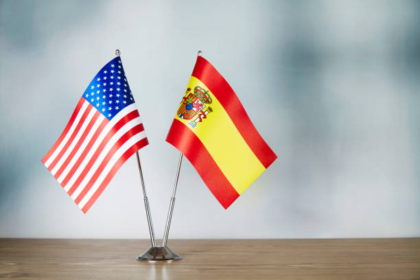 istock American and Spanish flag standing on the table 1138801064