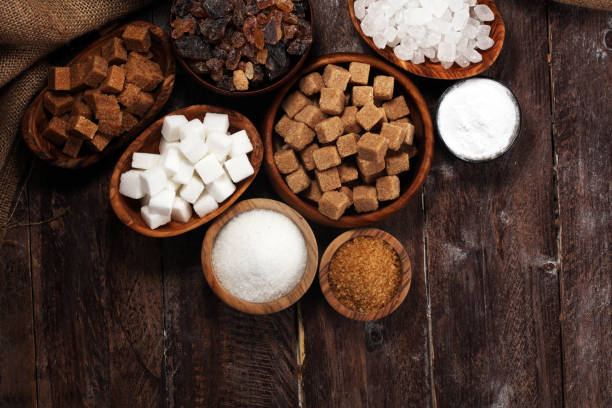 istock Various types of sugar, brown sugar and white on rustic wooden table 1138804309