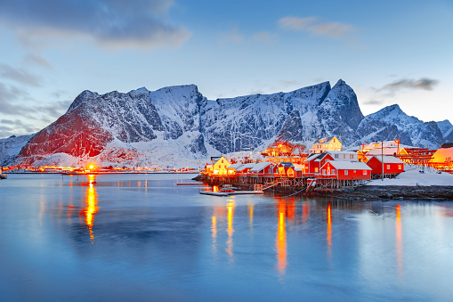 Moskenes island on Lofoten islands archipelago  in Norway over polar circle, Scandinavia, Europe - Lovely dusk scene of Villages Reine and Hamnoy: Reine fjord and snow-capped mountains in background.