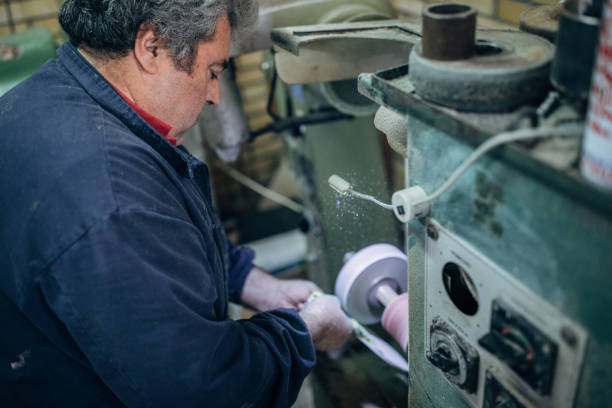 istock Mature man working on machine in shoe factory 1138805324